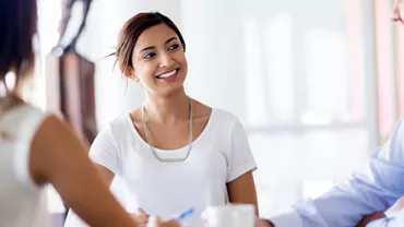 Woman smiling during a business meeting.